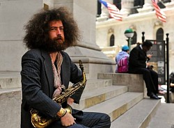 Sax with Slacks - Random musician performing at a street corner in the financial district. I sat down, spoke, and I offered him a shot.